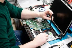 Business technician diagnosing computer hardware issues in a Green Bay office
